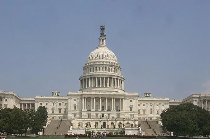 The US Capitol dome under a cloudy sky